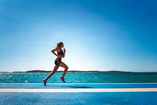 Woman running showing strong leg muscle Southend